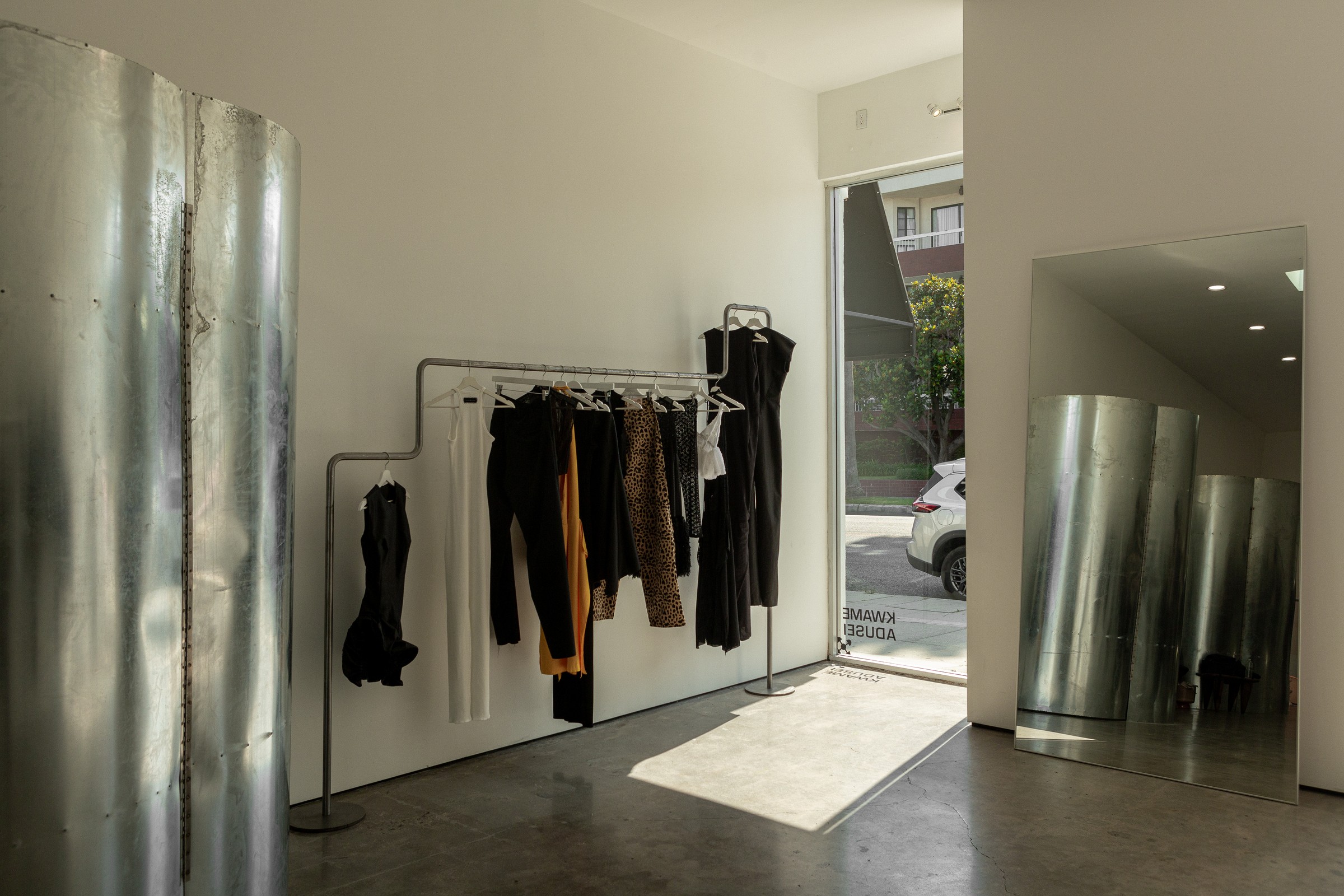 Wide interior, steel curved wall, glass door to street
