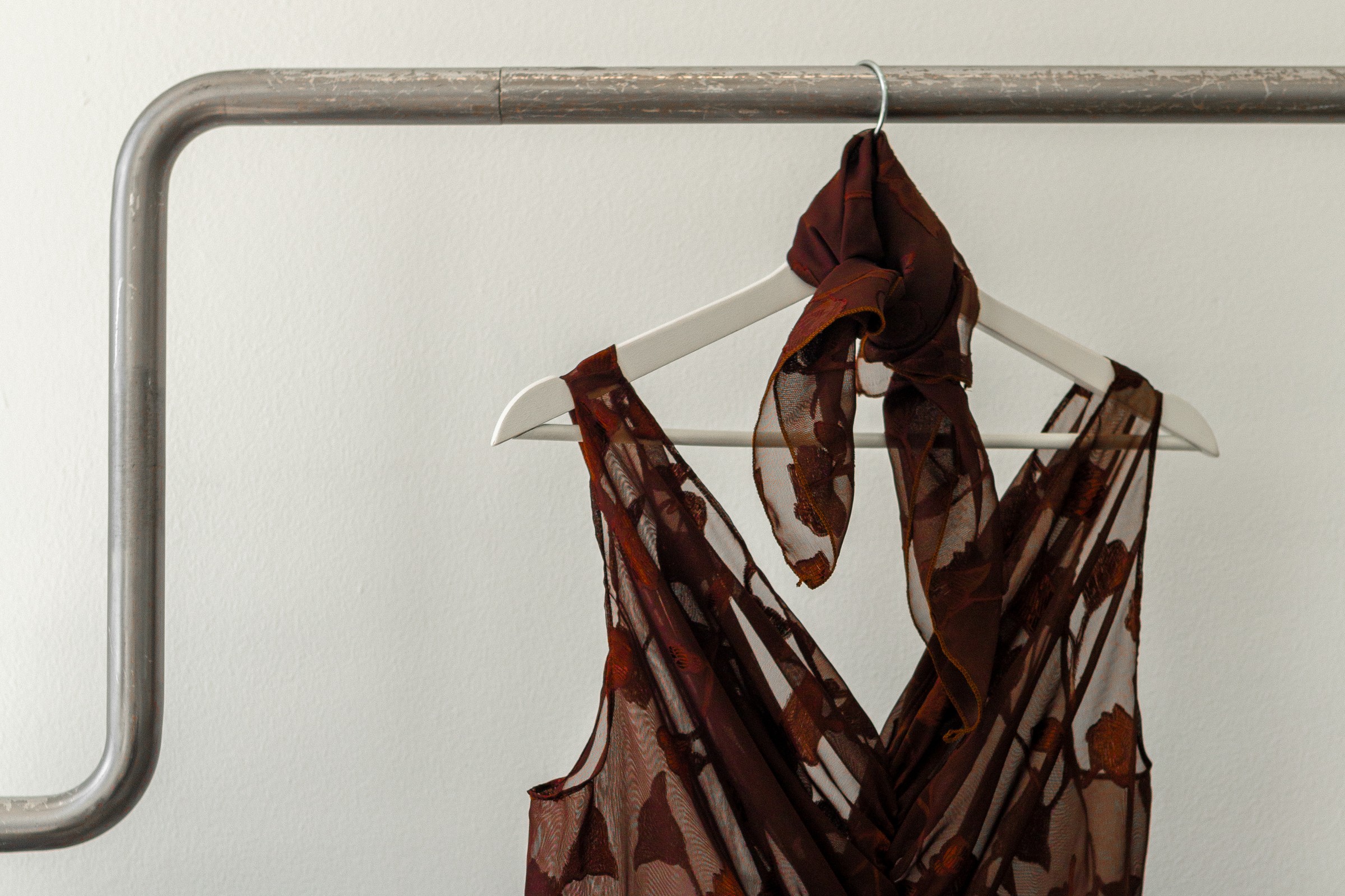 Burgundy dress on hanger