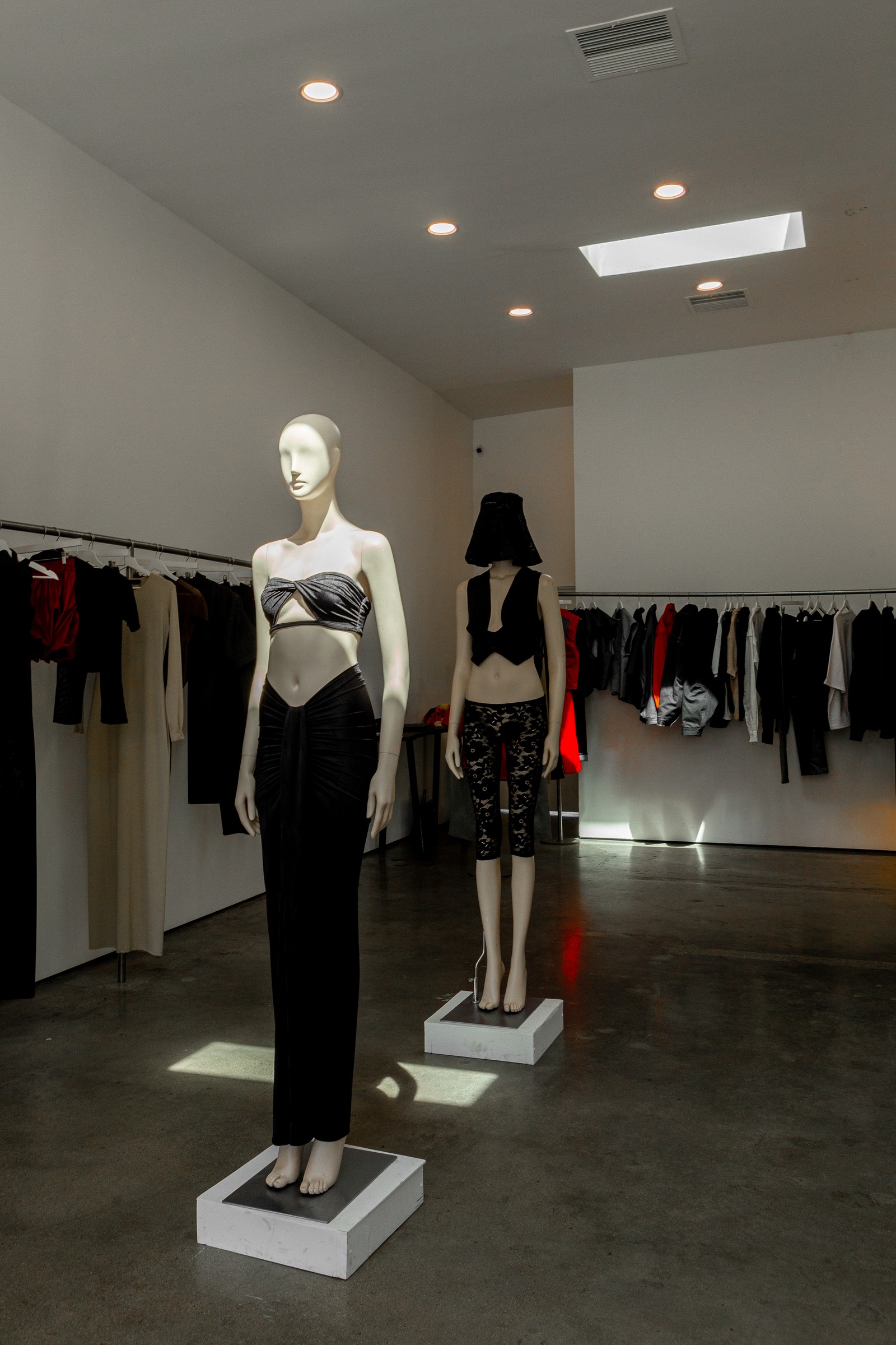 Two mannequins, deep hallway