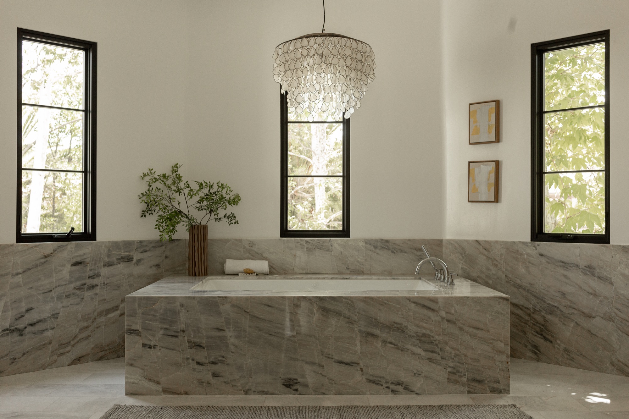 Primary bathroom, freestanding tub beneath a chandelier