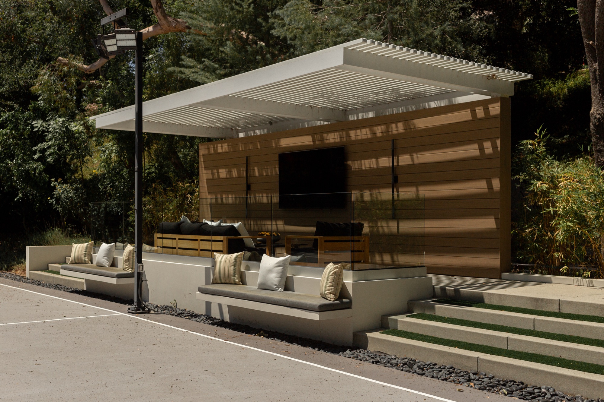 Outdoor cabana, built-in seating and television