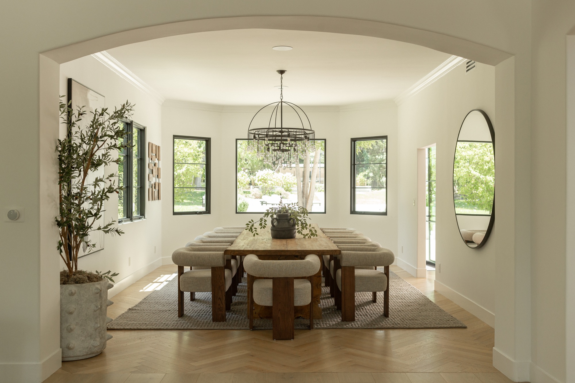 Dining room, long table and chandelier under a vaulted ceiling