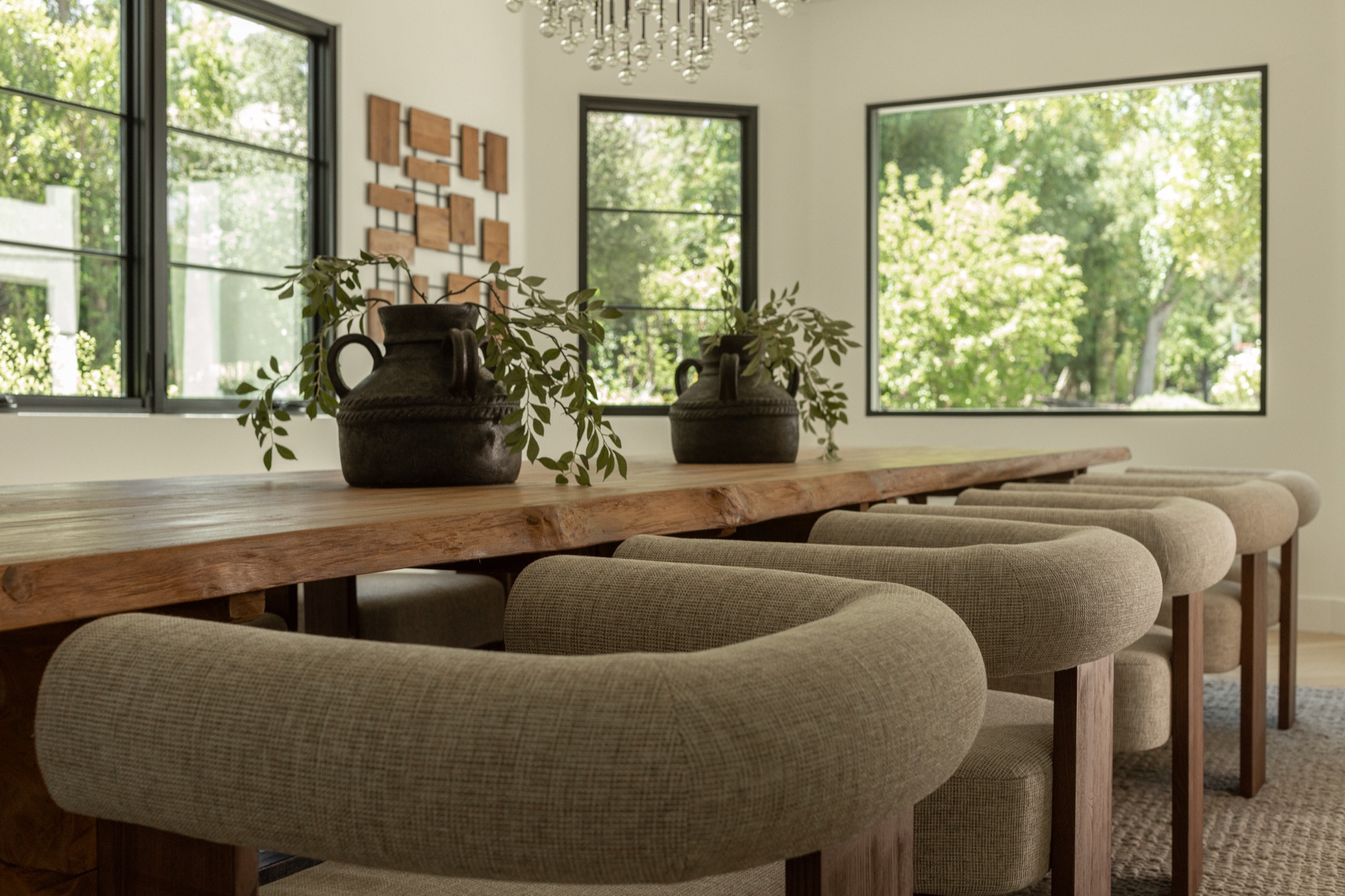 Dining room, table set with ceramic vessels and greenery