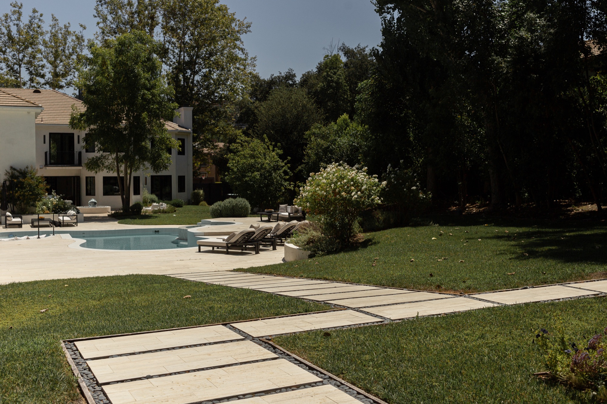 Backyard, path leading toward the pool and lawn