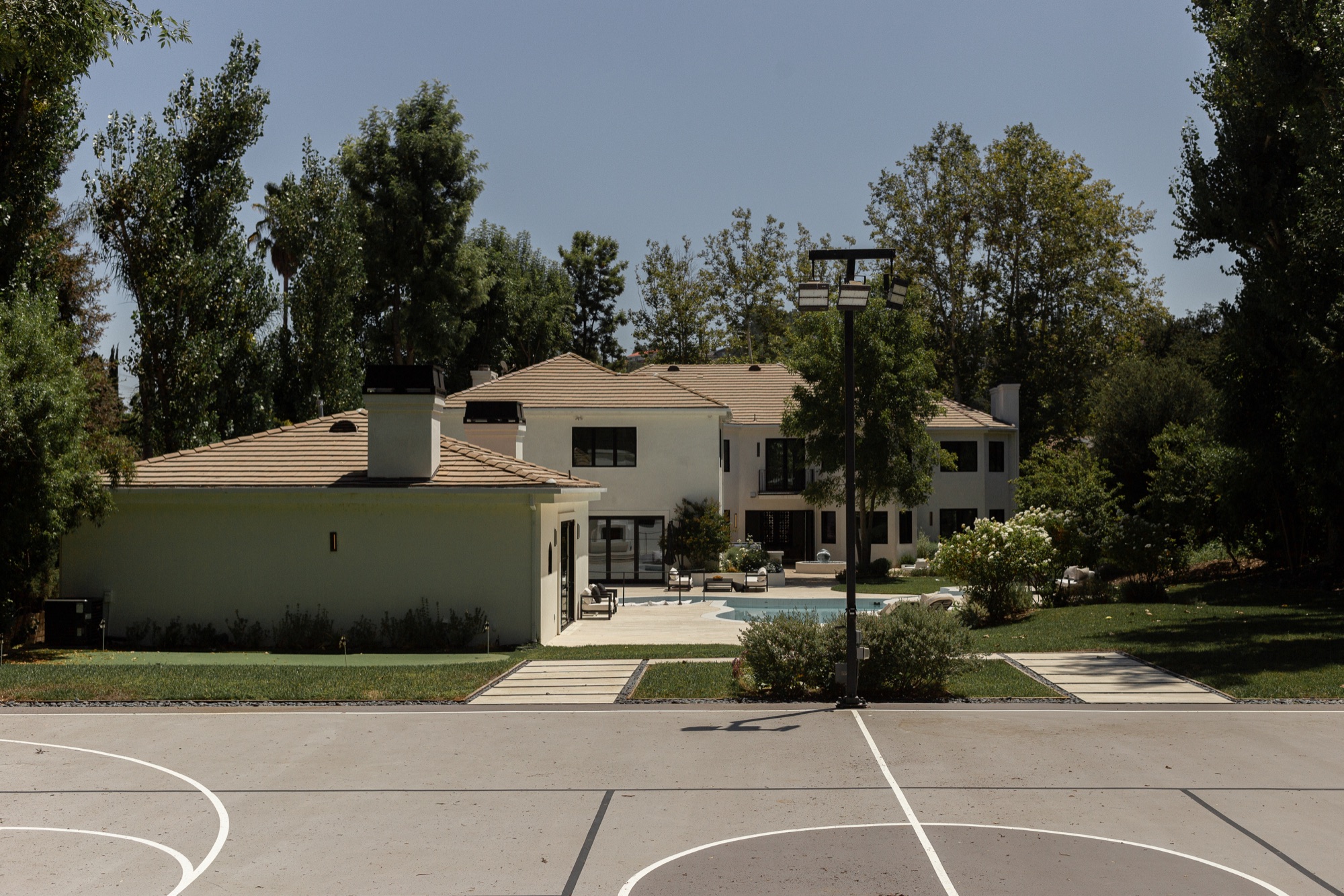 Rear exterior, wide, sport court, pool, and house