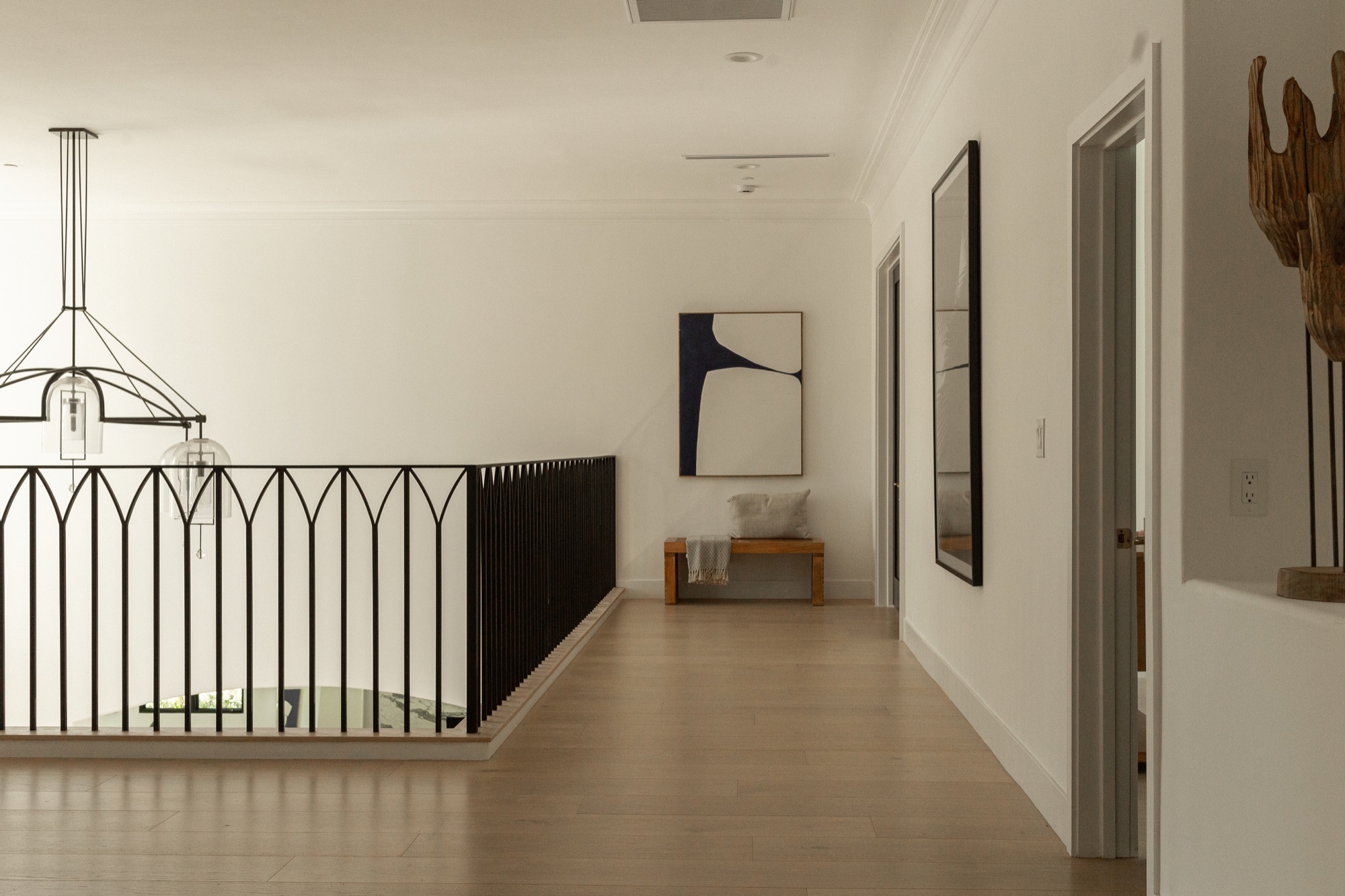 Upstairs hallway, iron railing and framed art