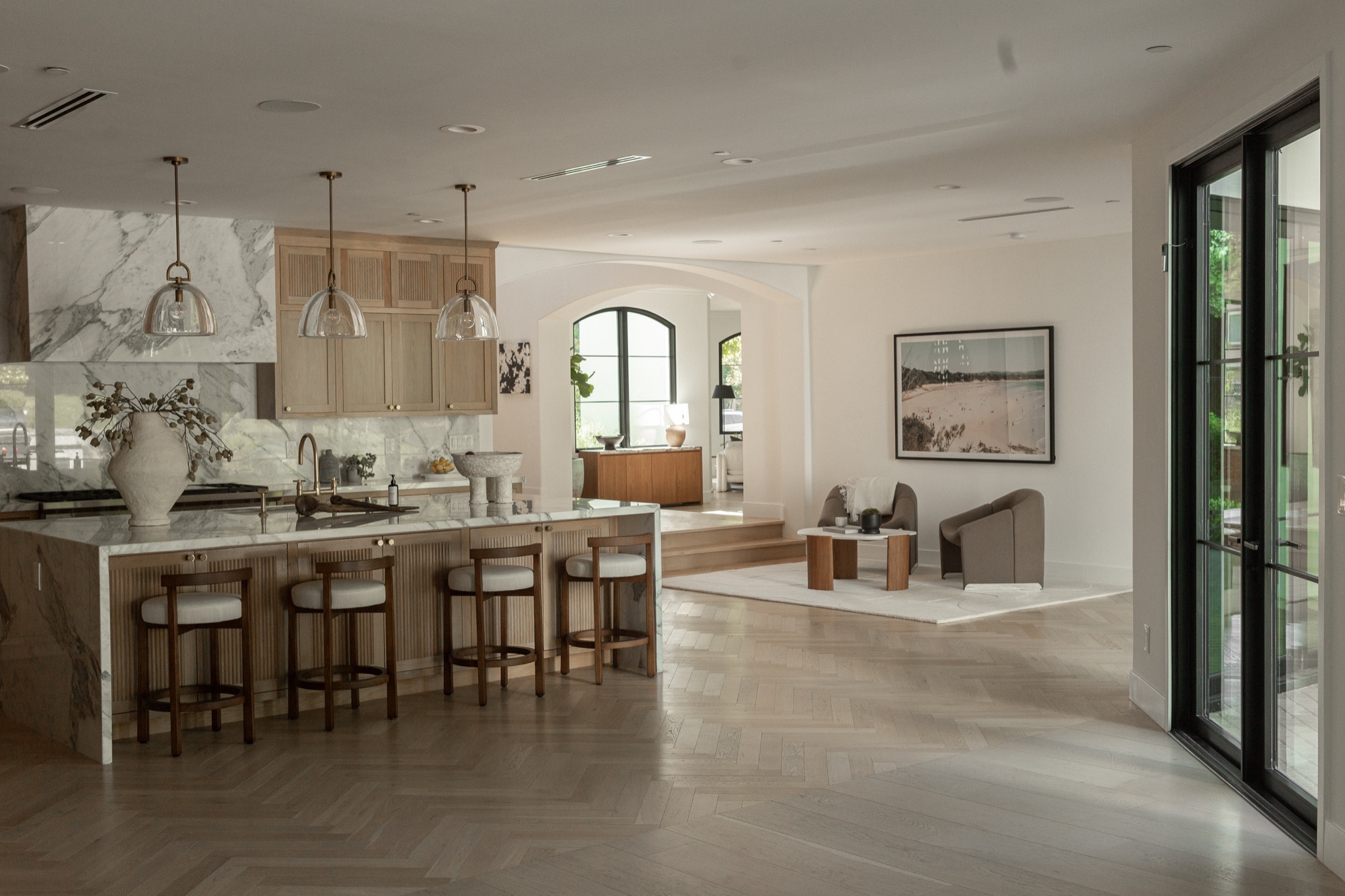 Kitchen, wide, island with pendant lighting and an adjoining sitting nook