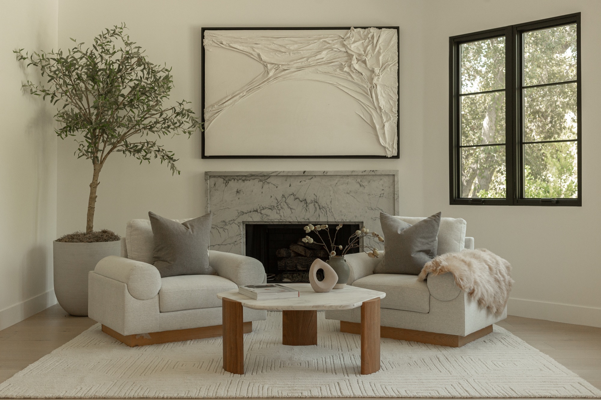 Living room, sculptural art above the marble fireplace mantel