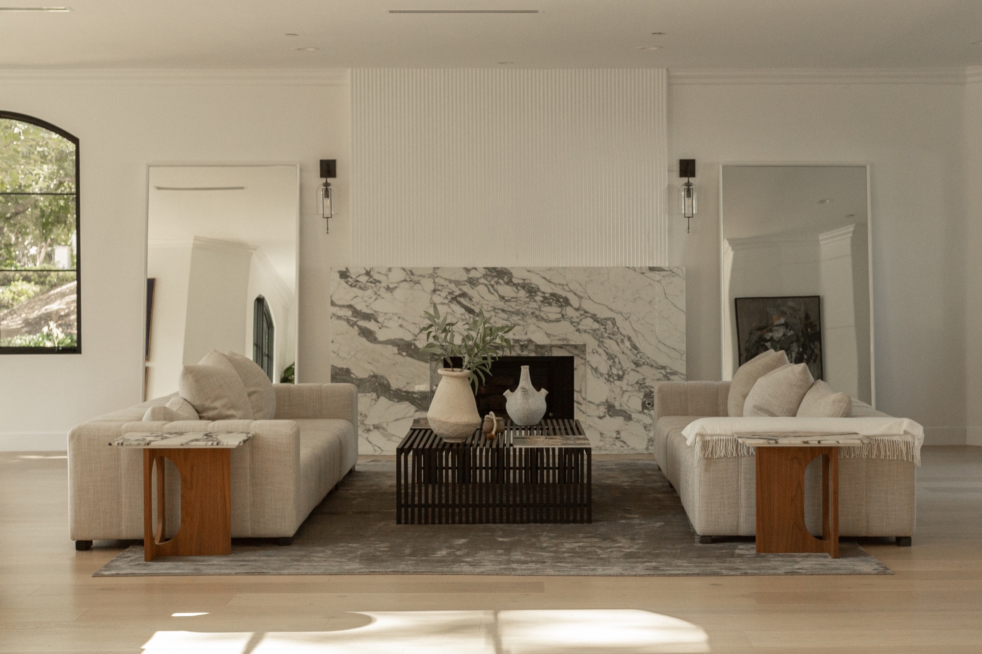 Living room, marble fireplace flanked by matching sofas
