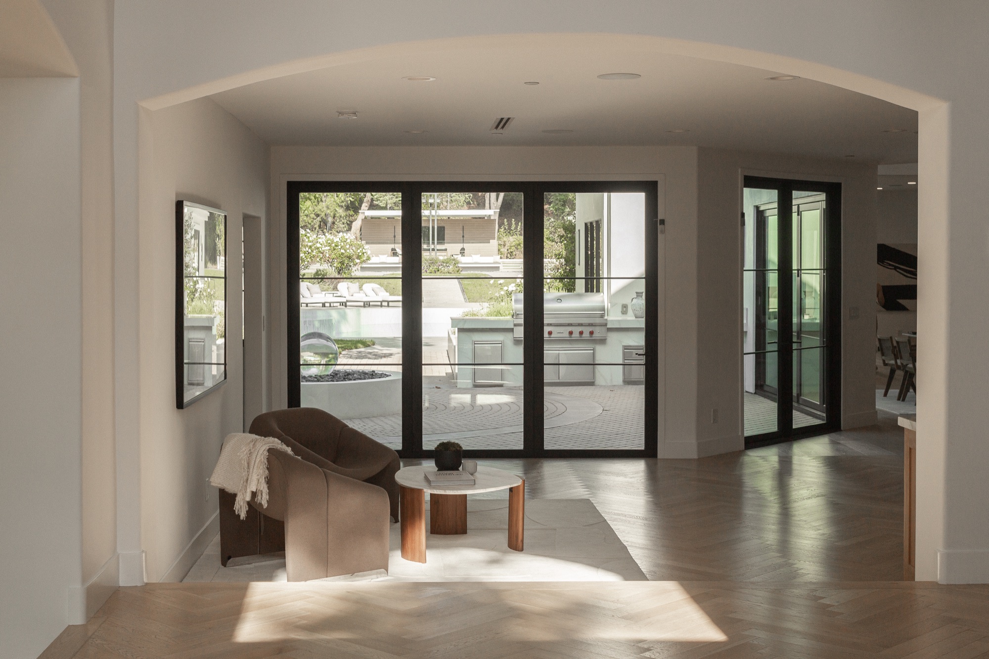 Living room opening to the backyard, armchair in the foreground