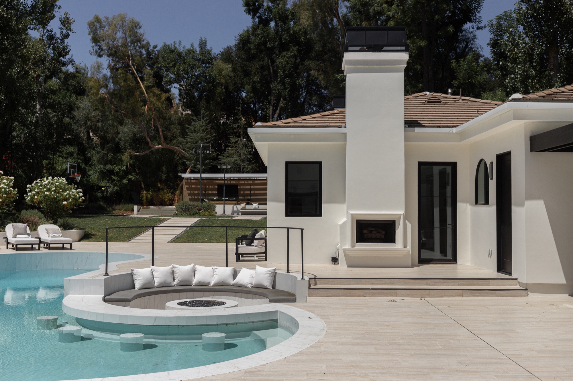 Backyard, pool with outdoor fireplace and lounge seating