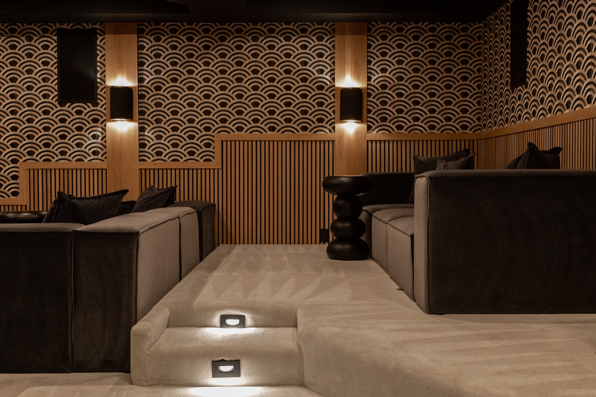 Home theater, patterned wall paneling and step lighting